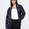 Strickjacke aus Baumwollmischung mit Fransen und Schalkragen